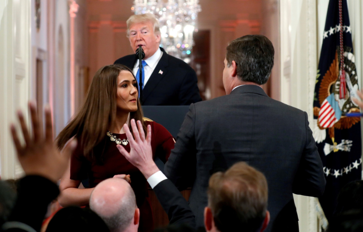 A White House staff member steps in to try to take the microphone away from CNN's Jim Acosta as he questions U.S. President Donald Trump during a news conference at the White House in Washington, on Nov. 7, 2018. (Kevin Lamarque/Reuters)