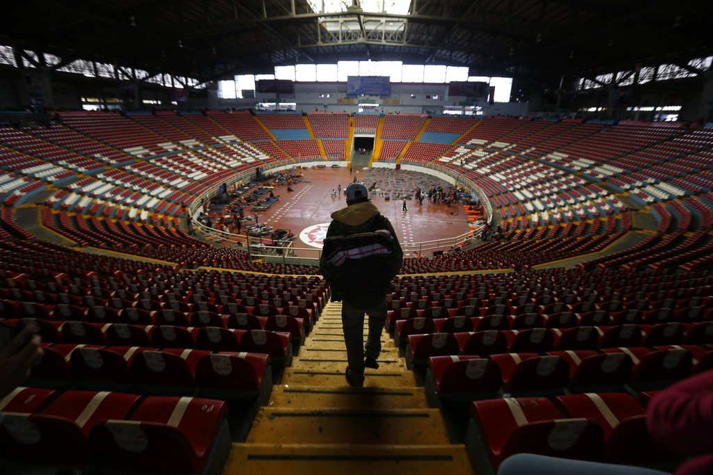 A Central American migrant, part of the caravan hoping to reach the United States border, arrives at the Benito Juarez Auditorium that is being as a migrant shelter, in Guadalajara, Mexico on Nov. 12, 2018. (AP Photo/Marco Ugarte)
