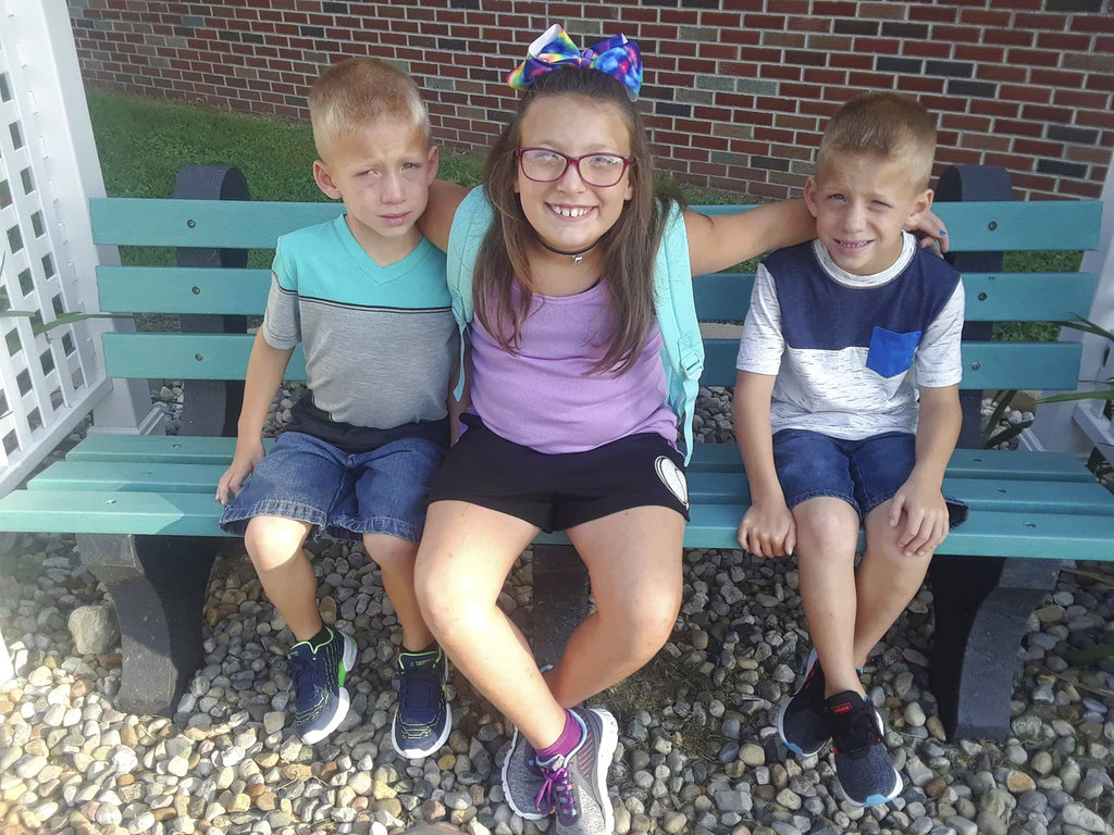 Alivia Stahl (C), and her twin brothers, Xzavier, and Mason Ingle in an undated photo, were killed in Rochester, Ind., on Oct. 30, 2018, after a driver failed to stop for a bus with warning lights and a stop arm activated. (Elgin Ingle via AP)