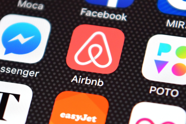 The Airbnb app logo is displayed on an iPhone on Aug. 3, 2016. (Carl Court/Getty Images)