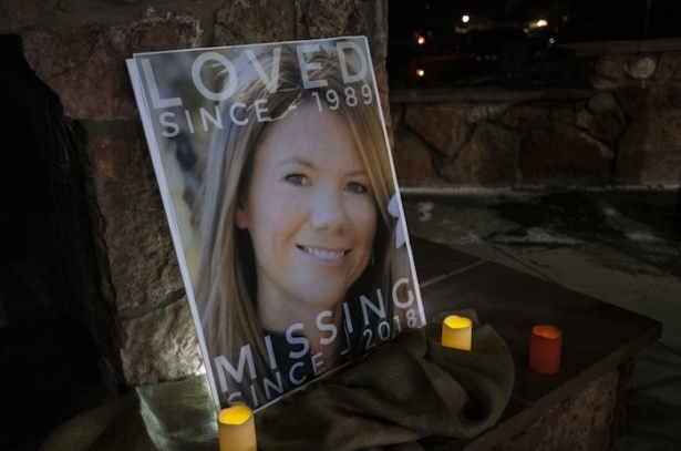A poster with the picture of the missing Kelsey Berreth is propped up with candles for a vigil Memorial Park in Woodland Park, Colo., on Dec. 13, 2018. (Kelsey Brunner/The Gazette via AP)