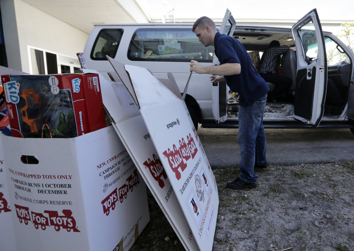 Stf. Sgt. Brian Spittler loads a vehicle with toy donations at the Marine Corps Toys for Tots depot, on Dec. 19, 2018, in Hialeah, Fla. (AP Photo/Lynne Sladky)