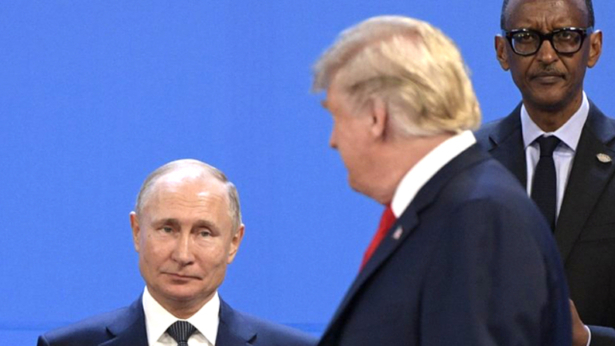 US President Donald Trump (R), looks at Russia's President Vladimir Putin as they take place for a family photo, during the G20 Leaders' Summit in Buenos Aires, on Nov. 30, 2018. (Juan Mabromata/AFP/Getty Images)