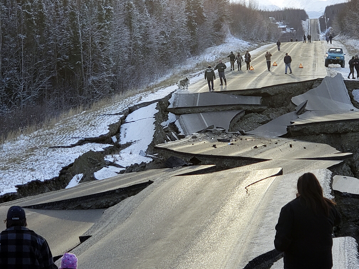 People walk along Vine Road after the earthquake on Friday, Nov. 30, 2018, in Wasilla, Alaska. (Jonathan M. Lettow via AP)
