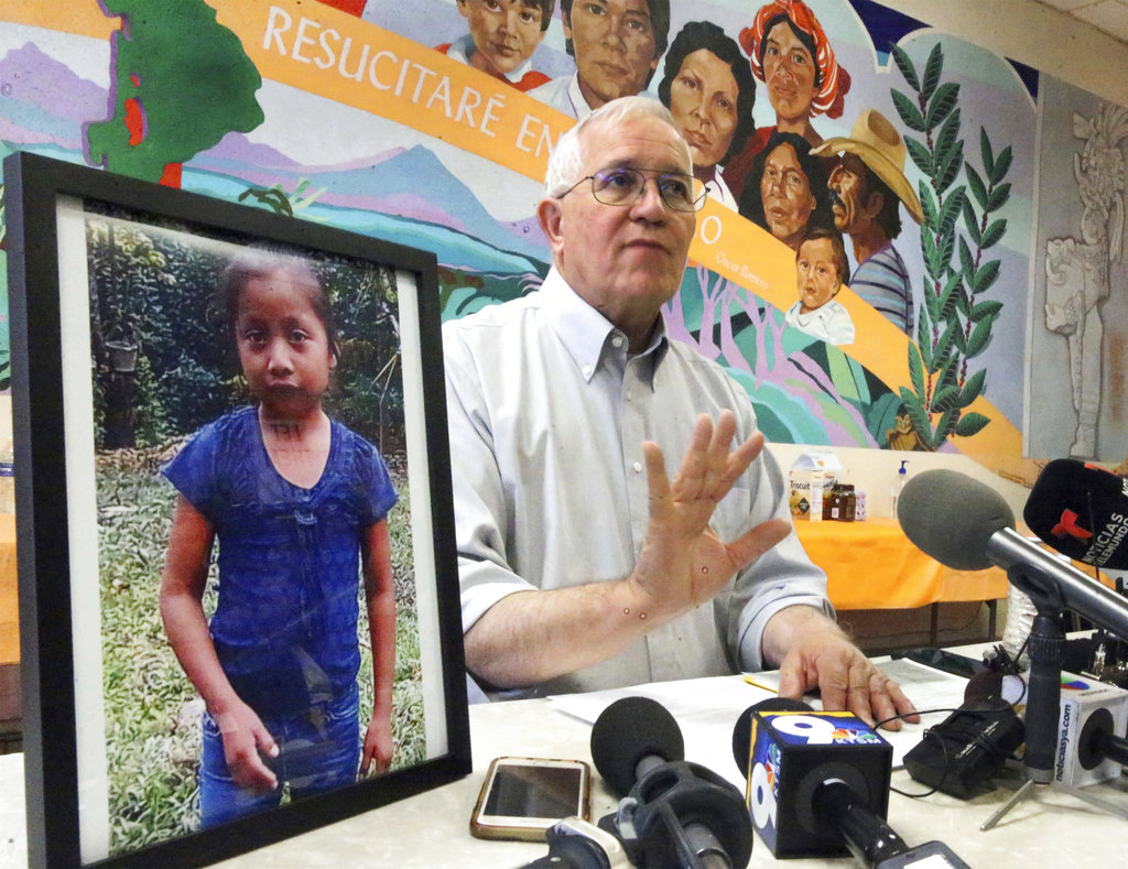 Annunciation House director Ruben Garcia answers questions from the media after reading a statement from the family of Jakelin Caal Maquin, pictured at left, during a press briefing at Casa Vides in downtown El Paso, Texas Dec. 15, 2018. (Rudy Gutierrez/The El Paso Times via AP)
