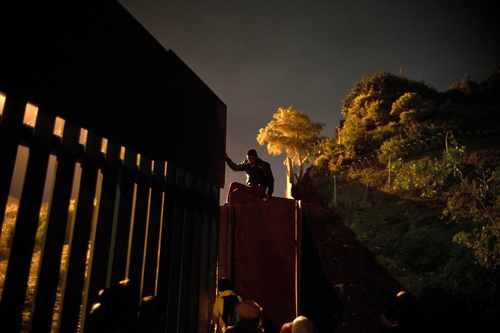 Man climbs border fence