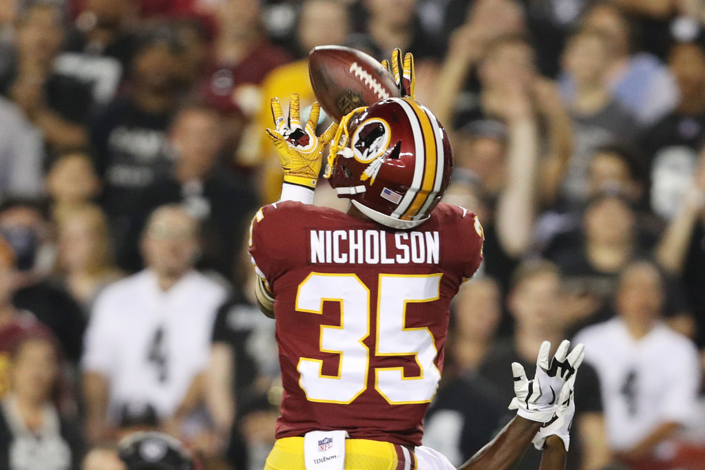 Strong safety Montae Nicholson No. 35 of the Washington Redskins makes an interception over wide receiver Amari Cooper No. 89 of the Oakland Raiders in the first quarter at FedExField in Landover, Md., on Sept. 24, 2017. (Patrick Smith/Getty Images)