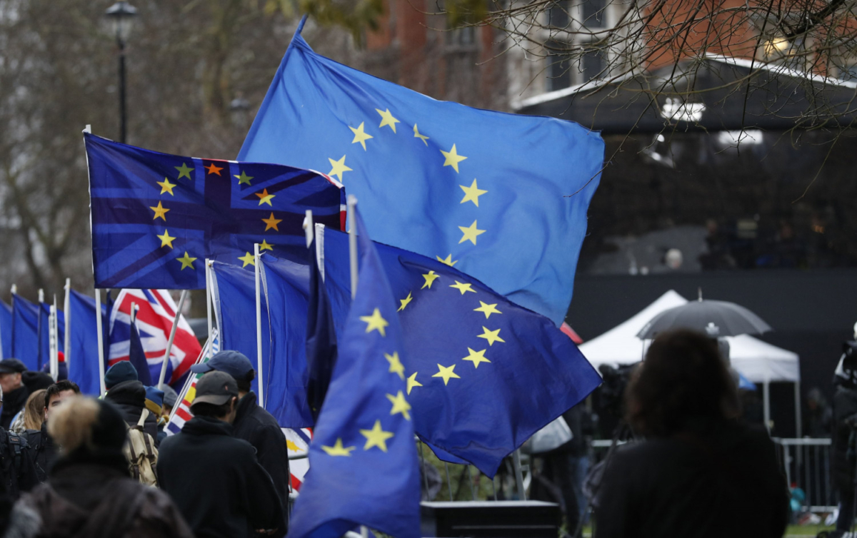 Anti-Brexit protesters demonstrate as the wind blows their EU and British flags near the Palace of Westminster in London, on Jan. 16, 2019. (Alastair Grant/AP)