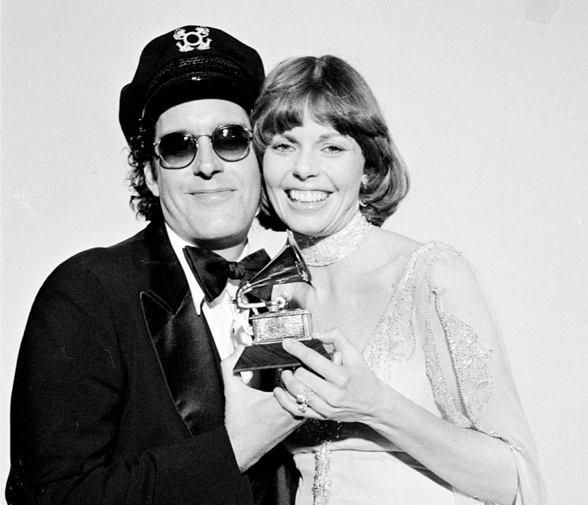 This photo shows Daryl Dragon and his wife Toni Tennille, of the Captain & Tennille, hold the Grammy award they won for record of the year for "Love Will Keep Us Together," at the Grammy Awards ceremony in Los Angeles. (AP Photo, FIle)