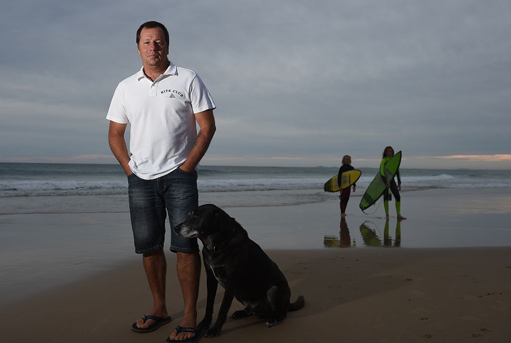 This photo taken on May 1, 2016 shows Australian shark attack victim Dave Pearson standing on Crowdy Head Beach, south of Ballina with his dog Mojo where he was attacked by a three metre Bull Shark in 2011. (Peter Parks/AFP/Getty Images)