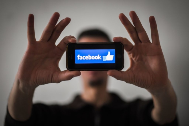 A man shows the logo of social network Facebook displayed on a smartphone in Nantes, France, on Jan. 15, 2019. (Loic Venance/AFP/Getty Images)