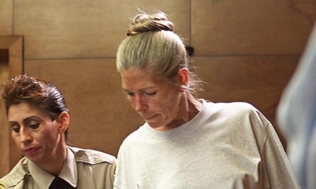 Corrections officer Sandra Fuentes assists Leslie Van Houten as she arrives for her parole hearing before members of the Board of Prison Terms, on June 28, 2002, at the California Institution for Women in Corona, California. (Damian Dovarganes/AFP/Getty Images)