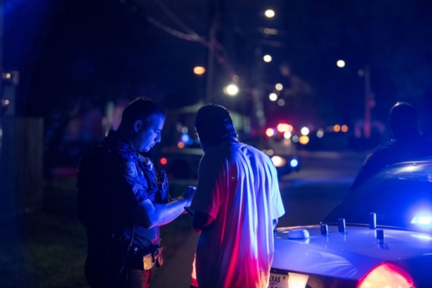 An officer assists a local resident trying to get to his home near the scene of a shooting where five Houston police officers were reported shot in Houston, Texas on Jan. 28, 2019. (Loren Elliott/Getty Images)
