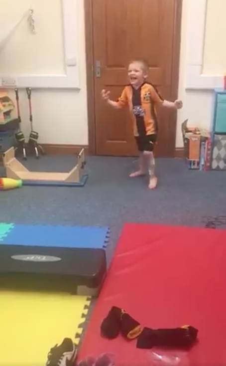 Four-year-old Ronnie with cerebral palsy shouts with joy as he walks his first steps without splints after an operation. (Steve Leys/Twitter)