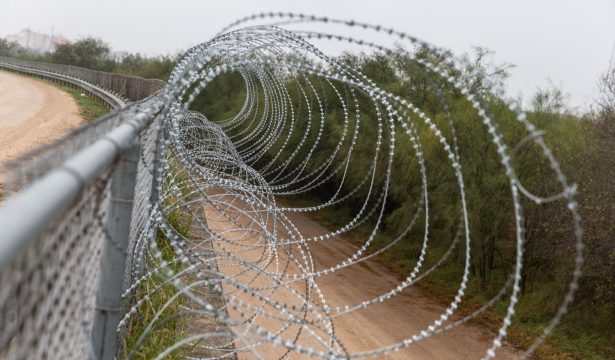 A fence with barbed wire on the US side of the US-Mexican border in McAllen, Texas on Jan. 15, 2019. (Suzanne Cordeiro/AFP/Getty Images)
