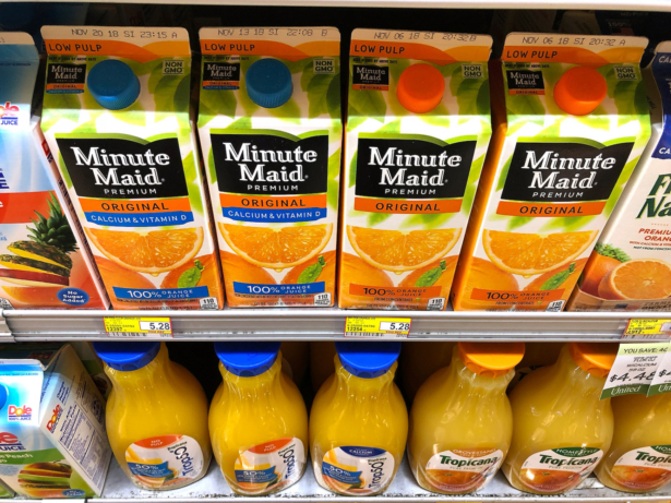 Containers of orange juice at grocery store. 