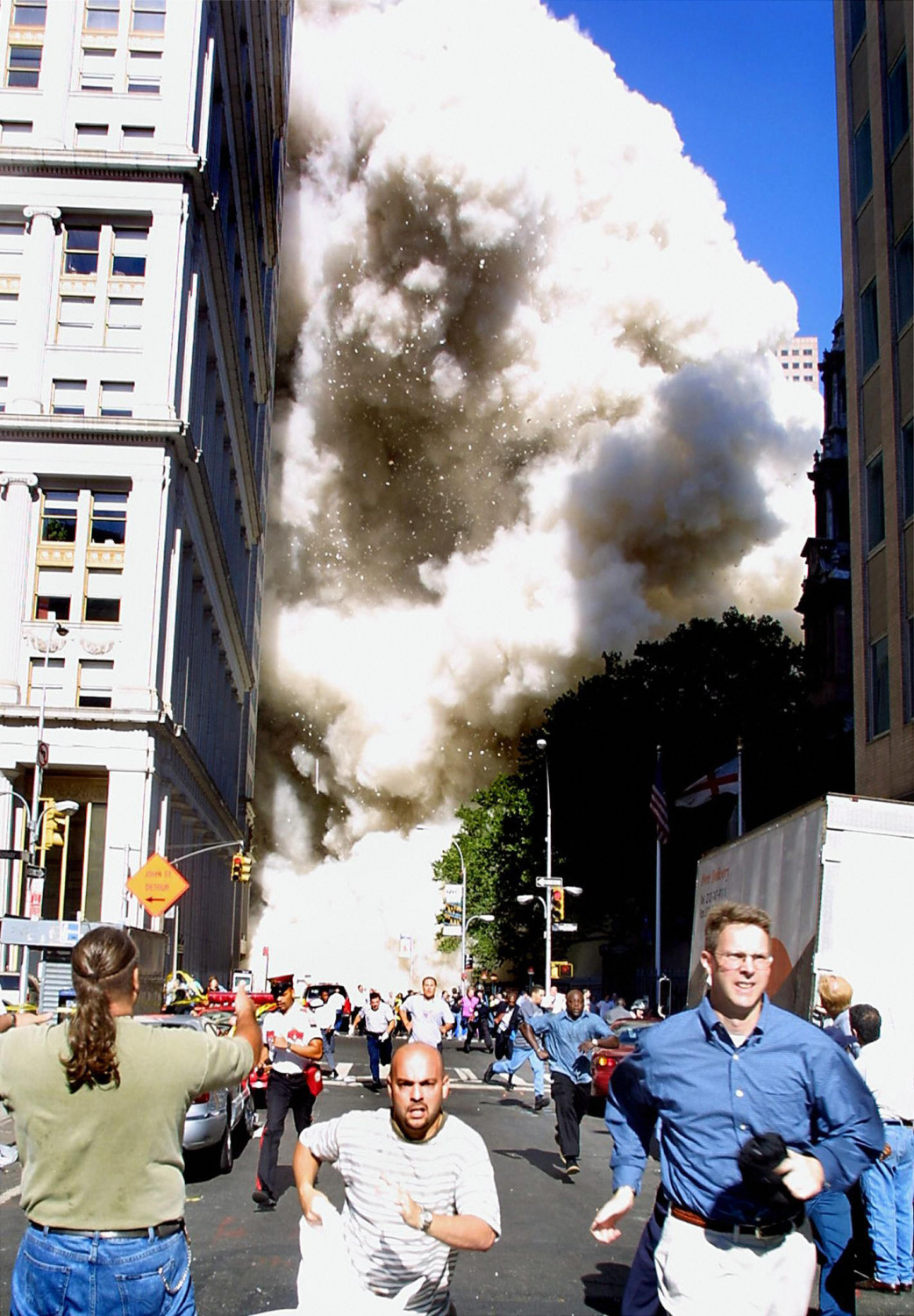 Pedestrians running from the scene as one of the World Trade Center towers collapses in New York City following a terrorist plane crash on the twin towers on 11 Sept. 2001.(Doug Kanter/AFP/Getty Images)