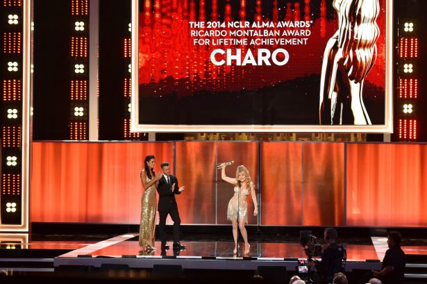Professional soccer player Jorge Bernal (C) presented singer Charo (R) the Ricardo Montalban Award for Lifetime Achievement during the 2014 NCLR ALMA Awards at the Pasadena Civic Auditorium in Pasadena, Calif., on Oct. 10, 2014. (Kevin Winter/Getty Images for NCLR)