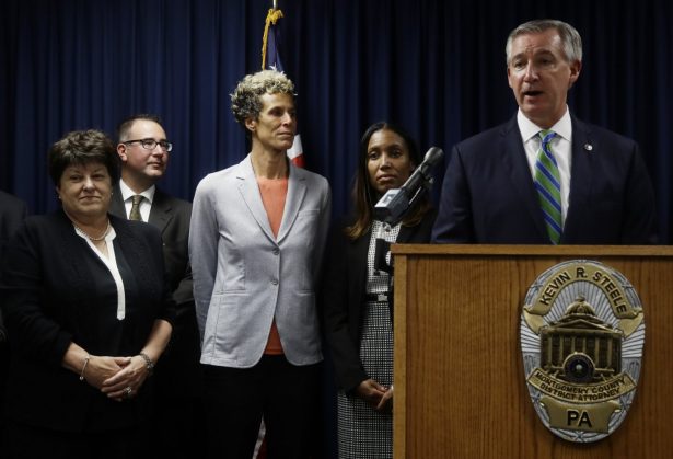 Accuser Andrea Constand, center, stands behind Montgomery County District Attorney Kevin Steele, right, at a news conference after Bill Cosby was sentenced to 3- to 10-years for sexual assault in Norristown, Pa., on Sept. 25, 2018. (Matt Slocum/AP Photo)