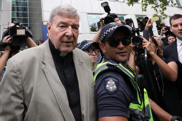 A police officer makes way for Cardinal George Pell as he leaves the County Court of Victoria court after prosecutors decided not to proceed with a second trial on alleged historical child sexual offences in Melbourne on Feb. 26, 2019. (Asanka Brendon Ratnayake/AFP/Getty Images)