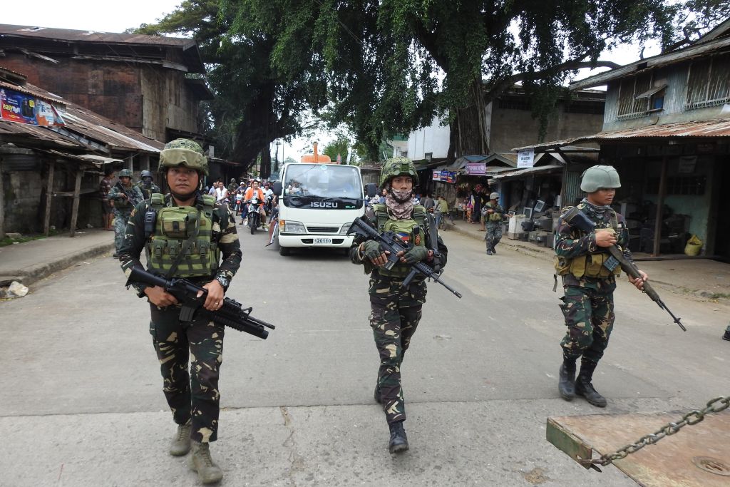 Philippine soldiers escort a hearse during the funeral procession of a victim killed in the January 27 cathedral bombing in Jolo, Sulu province on the southern island of Mindanao, on January 30, 2019. (Nickee Butlangan/AFP/Getty Images)