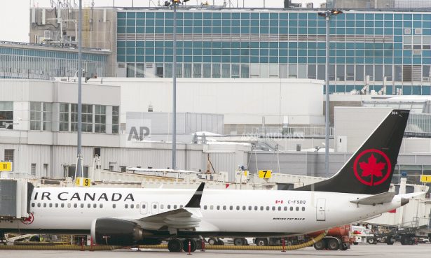 An Air Canada Boeing 737 Max 8 aircraft is parked next to a gate at Trudeau Airport in Montreal, March 13, 2019. (Graham Hughes/The Canadian Press via AP)