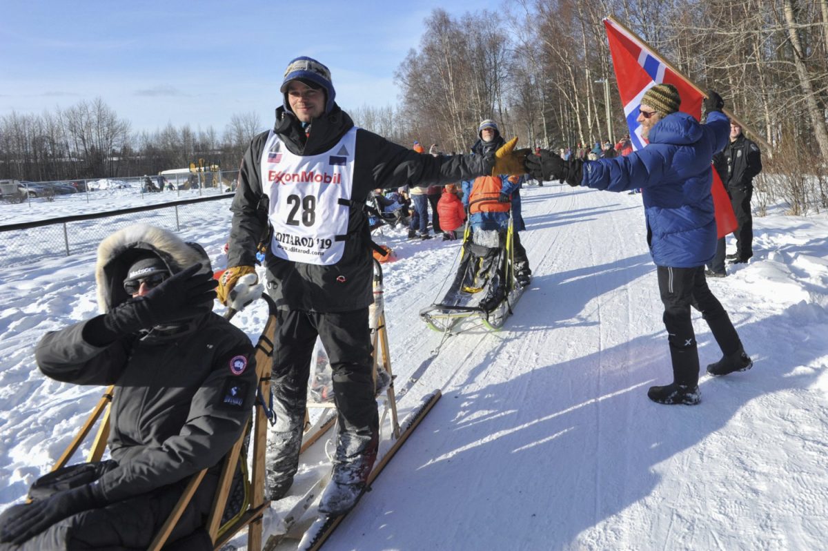 Defending champion Joar Leifseth Ulsom is greeted by local fan Ole Andersson during the ceremonial start of the Iditarod Trail Sled Dog Race in Anchorage, Alaska, on March 2, 2019 (Michael Dinneen/AP)