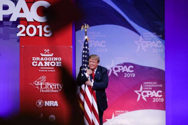 trump hugs flag at CPAC