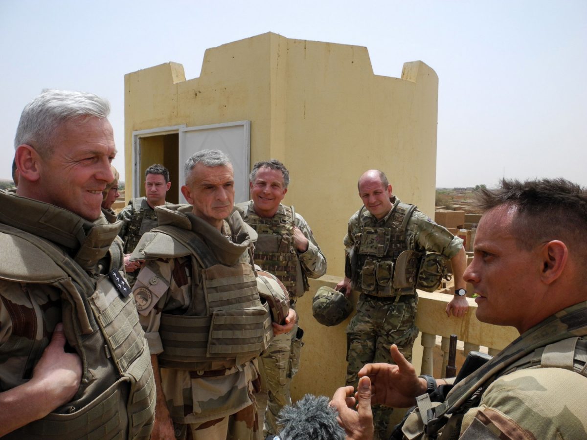 Chief of the General Staff of the French Armies General Francois Lecointre (L), flanked by commander of the Barkane force Frederic Blachon (C), meets troops on the roof of a building in Menaka, Mali, on March 21, 2019. (DAPHNE BENOIT/AFP/Getty Images)