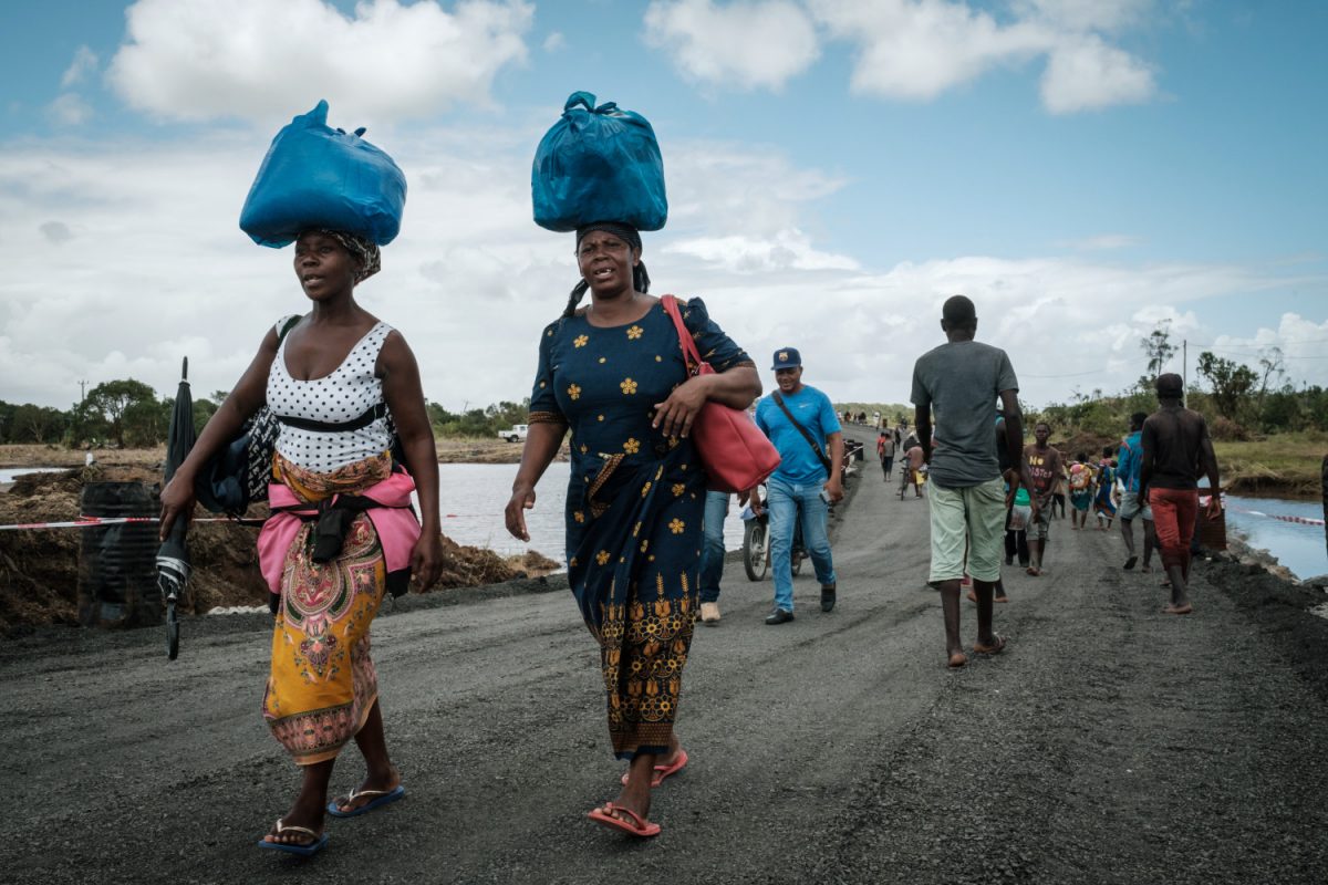 People walk on a reconstructed road after the original road was destroyed by the cyclone Idai in John Segredo, on March 24, 2019. (Yasuyoshi Chiba/AFP/Getty Images)