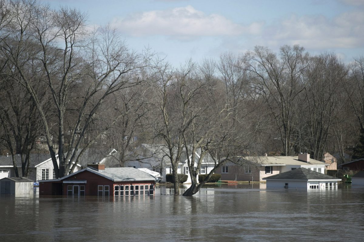 The Rock River crested its banks and floods Shore Drive, seen here on March 16, 2019, from the Bauer Parkway bridge in Machesney Park, Ill. Many rivers and creeks in the Midwest are at record levels after days of snow and rain. (Scott P. Yates/Rockford Register Star via AP)