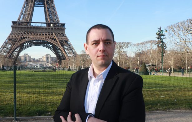 Police Syndicate Leader Michel Thooris poses in front of Eiffel Tower.