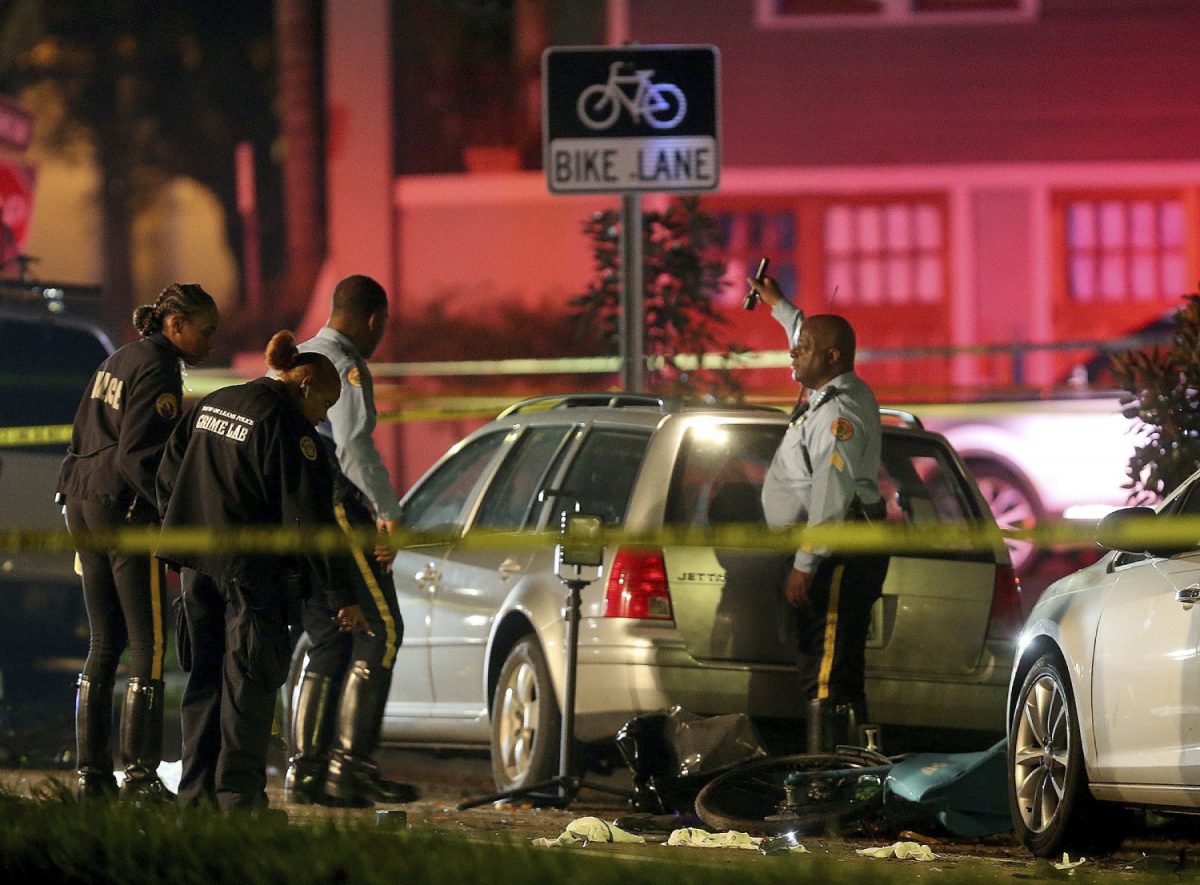 New Orleans Police examine damaged cars and bicycles on Esplanade Avenue in New Orleans after a car struck multiple people, killing several and injuring others following the Endymion Mardi Gras parade on March 2, 2019. (Michael DeMocker/NOLA.com/The Times-Picayune via AP)