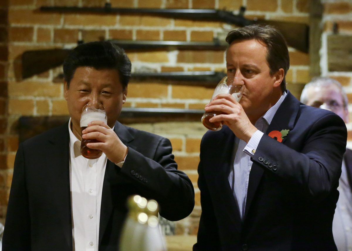 China's leader Xi Jinping and Britain's Prime Minister David Cameron drink a pint of beer during a state visit to the United Kingdom. Deals estimated to be worth £30 billion were agreed during the visit. (Kirsty Wigglesworth - WPA Pool/Getty Images)