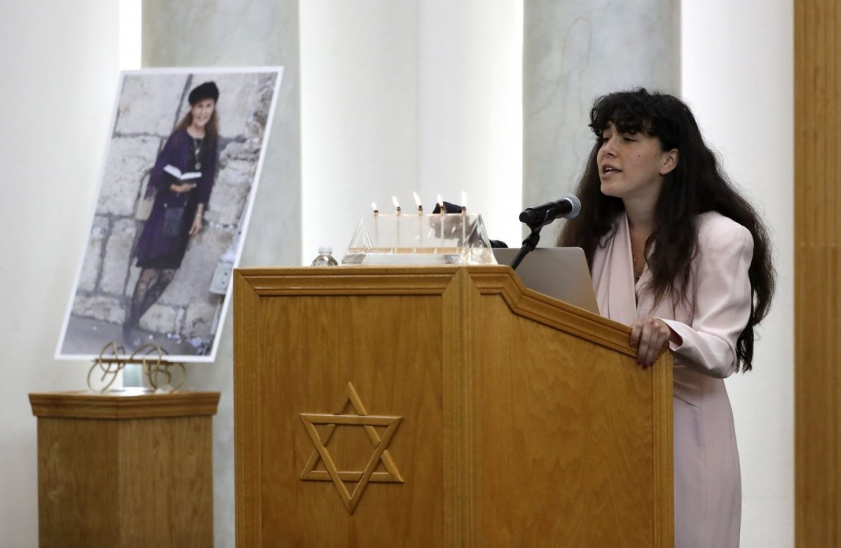 A photo of Lori Kaye, a victim of the synagogue shooting, is displayed in the Chabad synagogue as her daughter Hannah speaks during Kaye's funeral in Poway, Calif., on April 29, 2019. (Gregory Bull/The Associated Press)