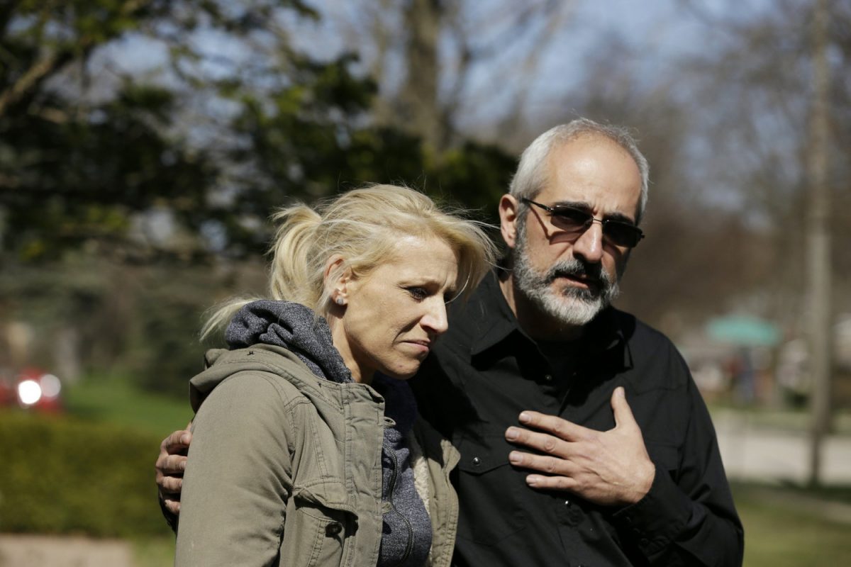 JoAnn Cunningham, the mother of missing 5-year-old child Andrew "AJ" Freund, stands with her attorney George Killis outside of the Freund home as he speaks on her behalf and pleads with the public to help find AJ in Crystal Lake, Ill., on April 19, 2019. (Stacey Wescott/Chicago Tribune via AP)