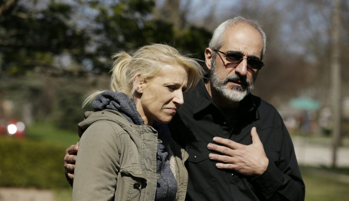 JoAnn Cunningham, the mother of Andrew "AJ" Freund, stands with her attorney George Killis outside the Freund home as he speaks on her behalf and pleads with the public to help find AJ in Crystal Lake, Ill., on April 19, 2019. (Stacey Wescott/Chicago Tribune via AP)