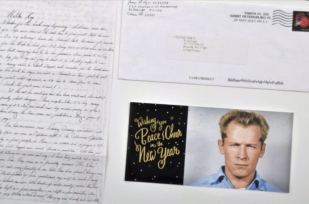 A hand-written letter by the late mobster James "Whitey" Bulger and his 1959 Alcatraz mugshot. The items were auctioned on Sunday, Feb. 24, 2019. (Darin Rone/Urban Culture Auctions via The Associated Press)