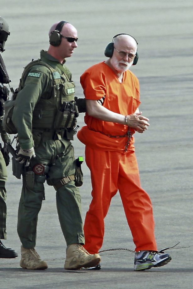 James "Whitey" Bulger, right, is escorted from a U.S. Coast Guard helicopter to a waiting vehicle at an airport in Plymouth, Mass., after attending hearings in federal court in Boston, on June 30, 2011.(Stuart Cahill/The Boston Herald via AP, File)