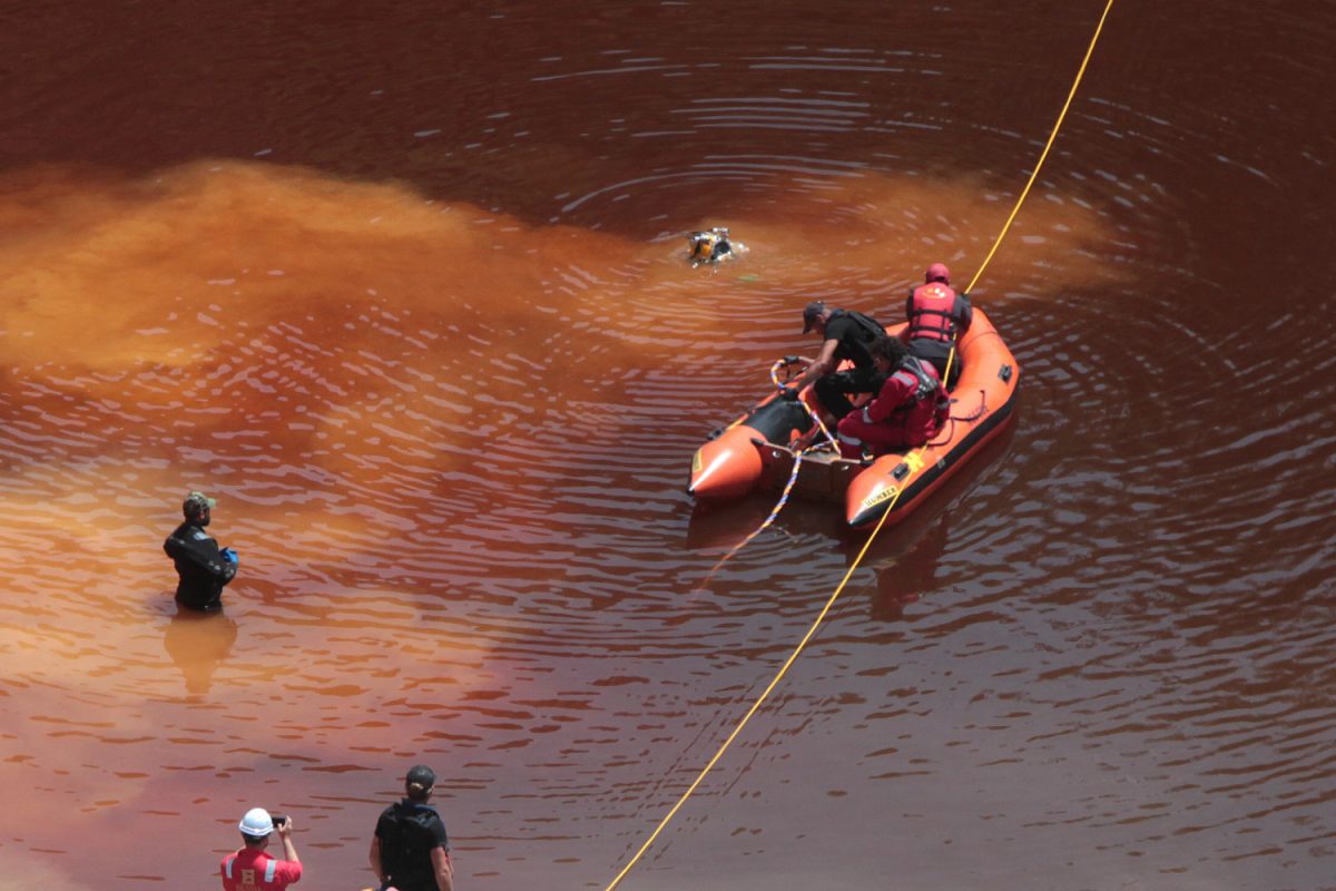 Police forensics officers, rescuers and divers retrieve a suitcase, which police say contains a female body, during an investigation for possible bodies of victims of a suspected serial killer in Kokkinopezoula lake, also known as "red lake", near the village of Mitsero, Cyprus on April 28, 2019. (Marinos Meletiou via Reuters)