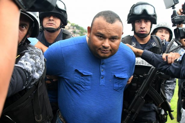 Honduran convicted drug trafficker Noe Montes Bobadilla aka "Tom" is escorted by agents of the Tigres special force of the National Police upon his arrival in Tegucigalpa on June 14, 2017. (ORLANDO SIERRA/AFP/Getty Images)