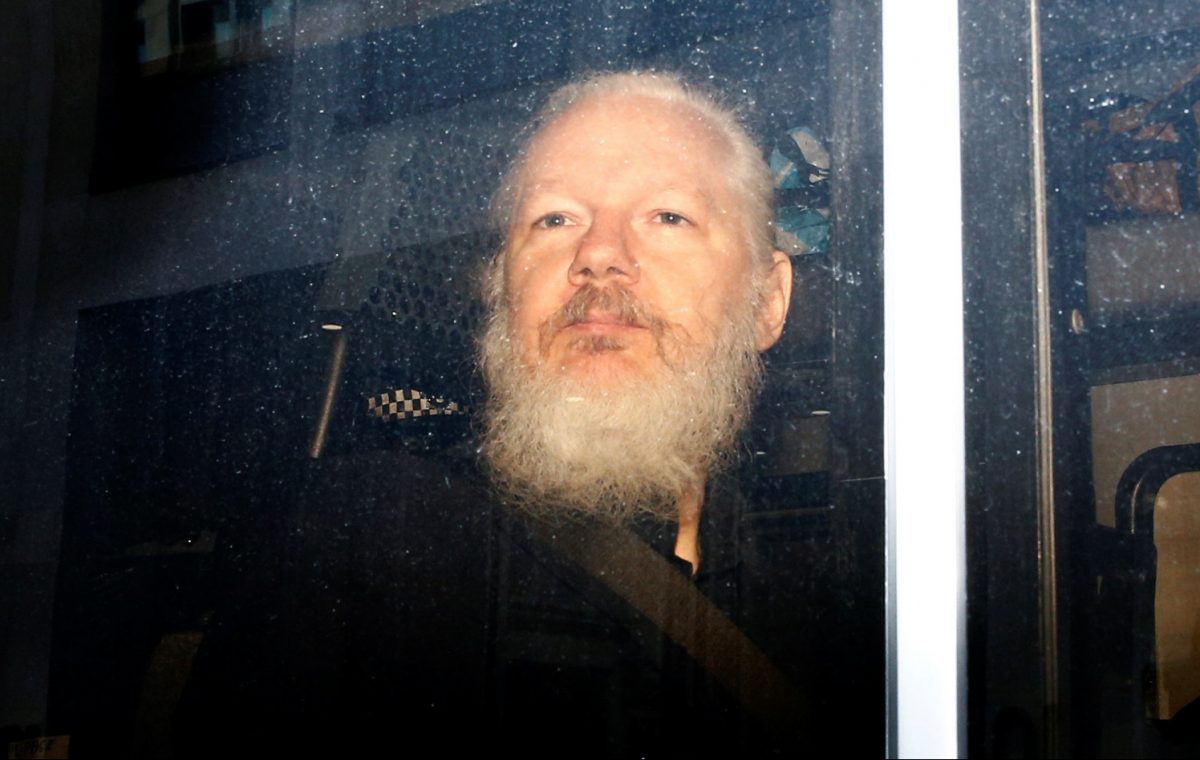 WikiLeaks founder Julian Assange is seen in a police van, after he was arrested by British police, in London, Britain on April 11, 2019. (Henry Nicholls/Reuters)