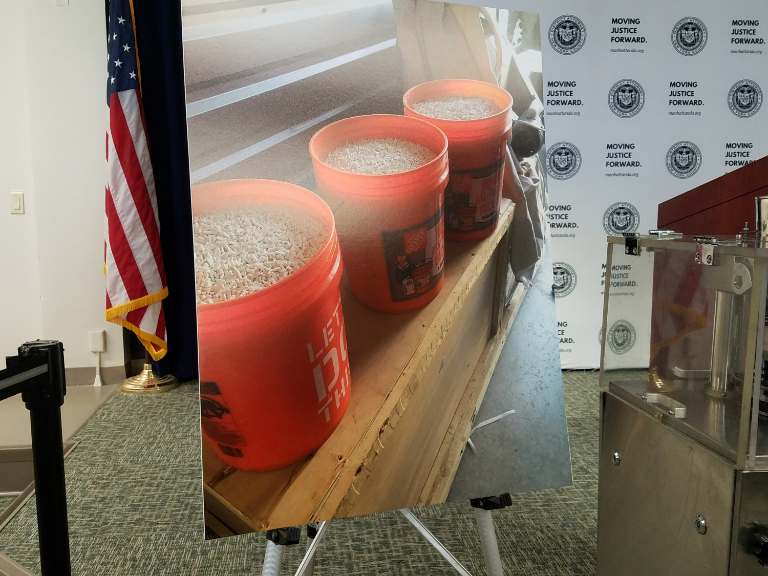 Picture of three orange buckets filled with pills at the Manhattan District Attorney's office, New York, on April 16, 2019. (Miguel Moreno/The Epoch Times)