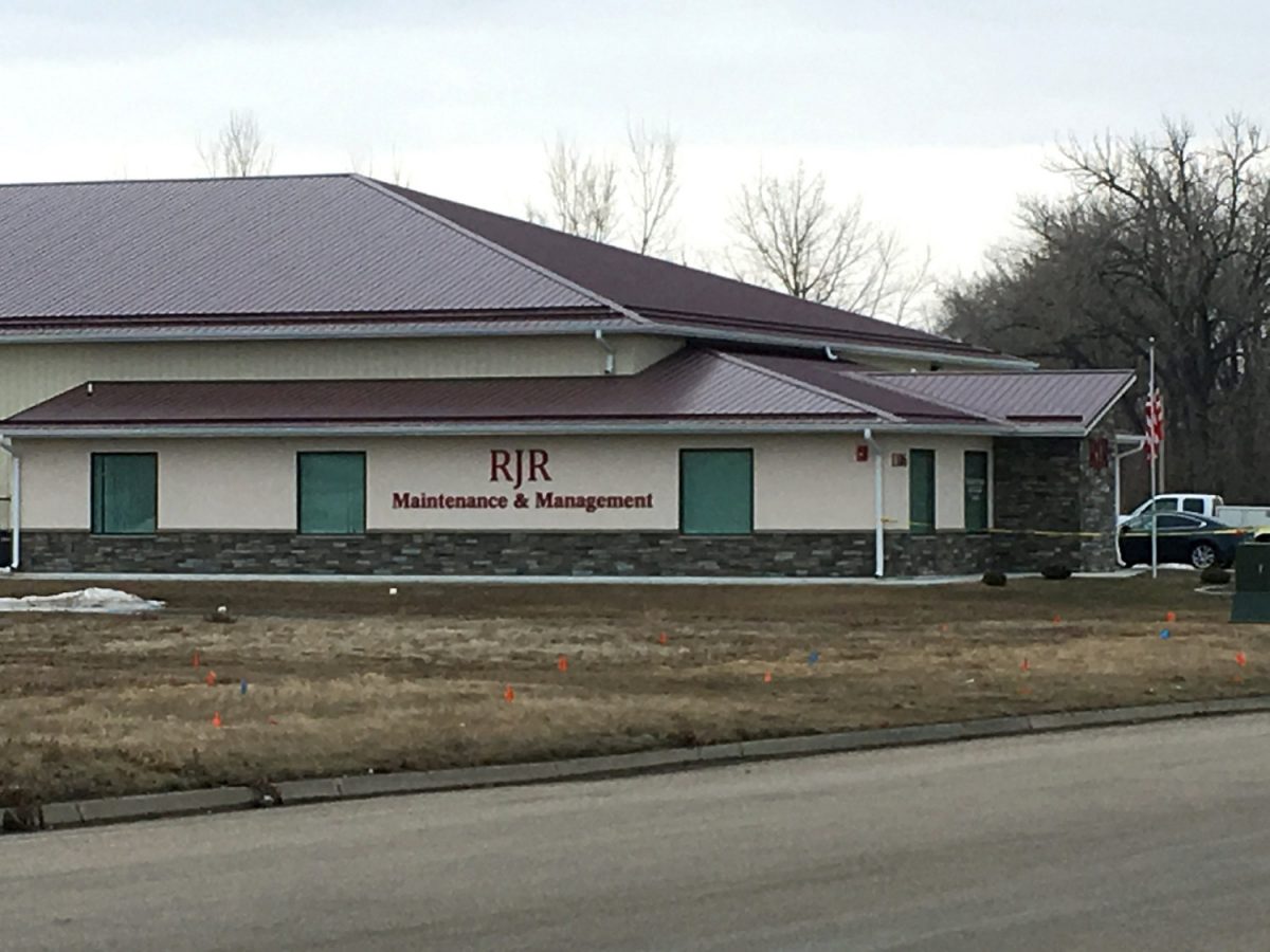 Cars are parked outside RJR Maintenance and Management in Mandan, N.D., on April 1, 2019. (Mike McCleary/The Bismarck Tribune via AP)
