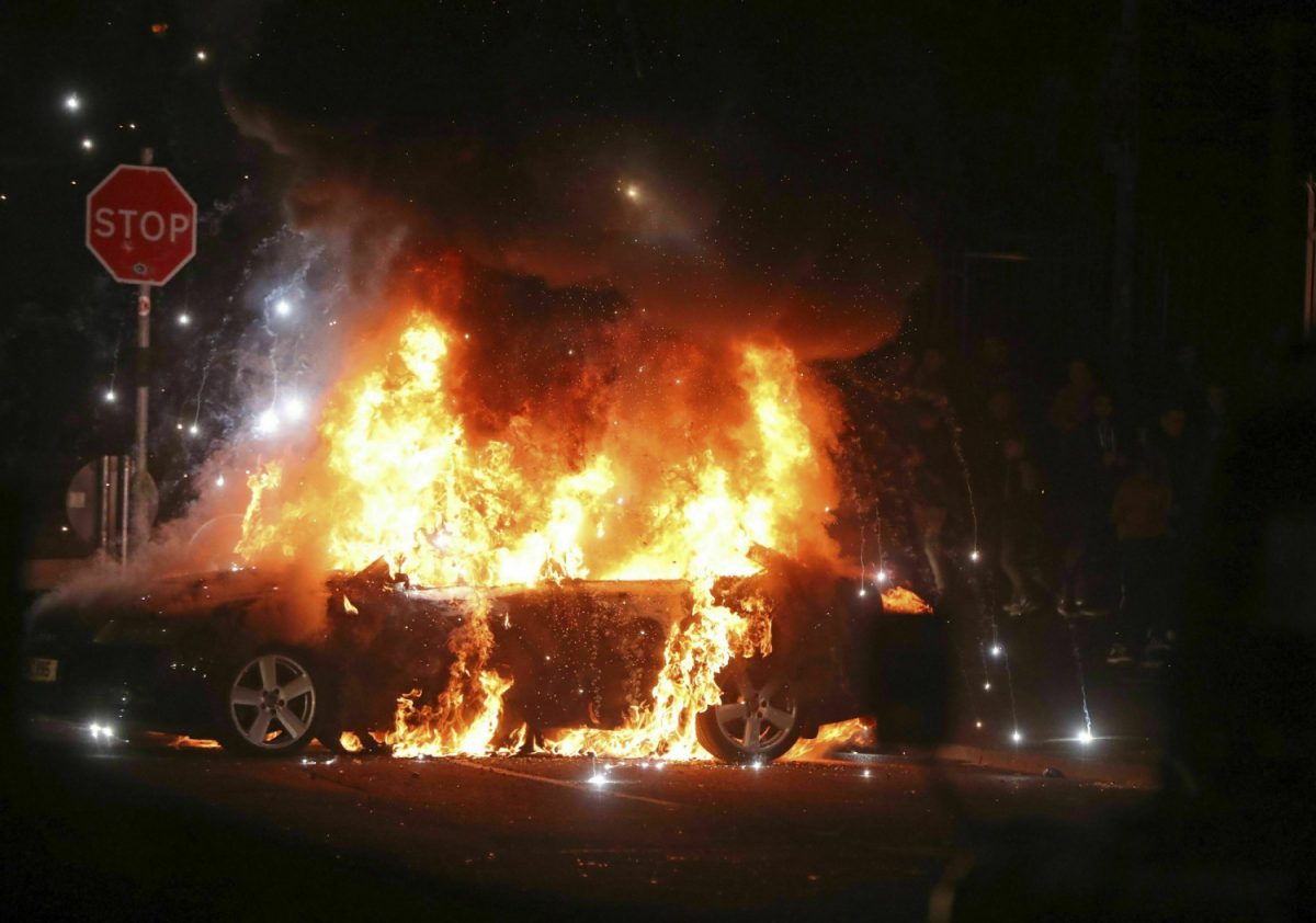 A car burns after petrol bombs were thrown at police in the Creggan area of Londonderry, in Northern Ireland, on April 18, 2019. (Niall Carson/PA via AP)