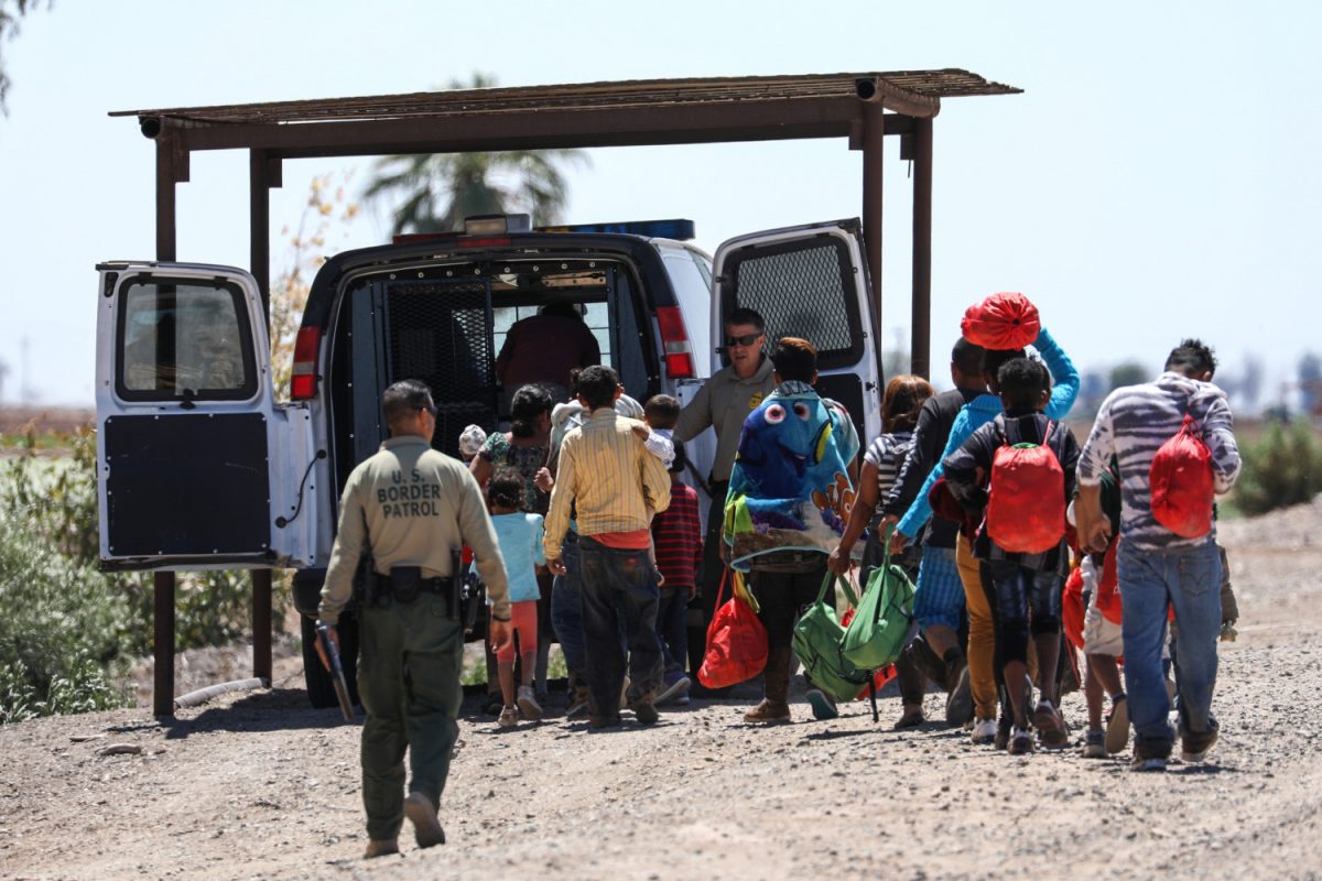 A group of illegal aliens is processed by Border Patrol agents after crossing from Mexico into Yuma, Ariz., on April 13, 2019. (Charlotte Cuthbertson/The Epoch Times)