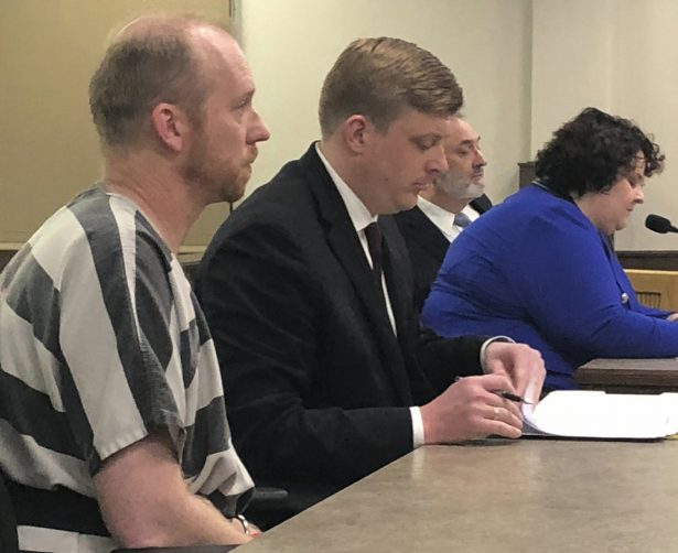 Chad Isaak, left, appears in court in Mandan