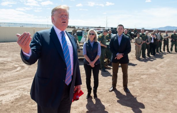 President Donald Trump speaks with members of the U.S. Customs and Border Patrol as he tours the border wall between the United States and Mexico in Calexico, Calif., on April 5, 2019. (Saul Loeb/AFP/Getty Images)
