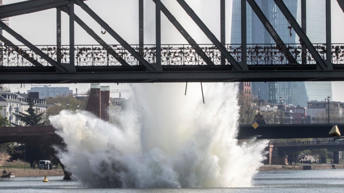 A large water fountain rises behind the Iron Bridge when an American bomb from the Second World War in the Main River is detonated with a blast in Frankfurt, Germany, on April 14, 2019. (Frank Rumpenhorst/dpa via AP)