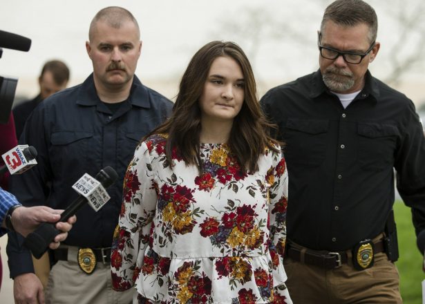 Santana Renee Adams is escorted into Cabell County Magistrate Court to be arraigned on charges for falsely reporting an emergency incident in Huntington, W.Va on April 5, 2019. (Sholten Singer/The Herald-Dispatch via AP)